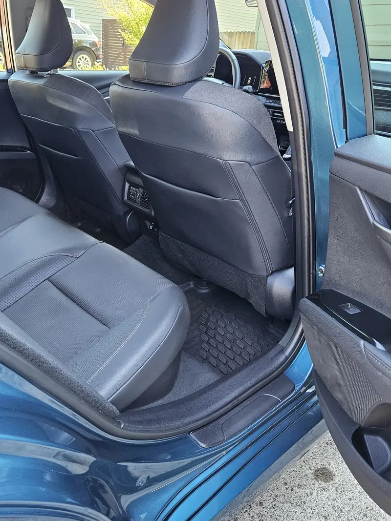 Rear door and seats of a 2025 Toyota Camry open after interior detailing