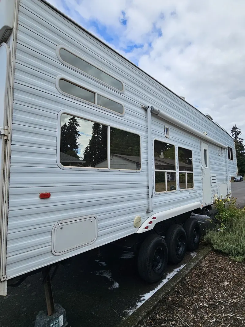 Side of a 2006 Weekend Warrior fifth wheel RV after exterior cleaning